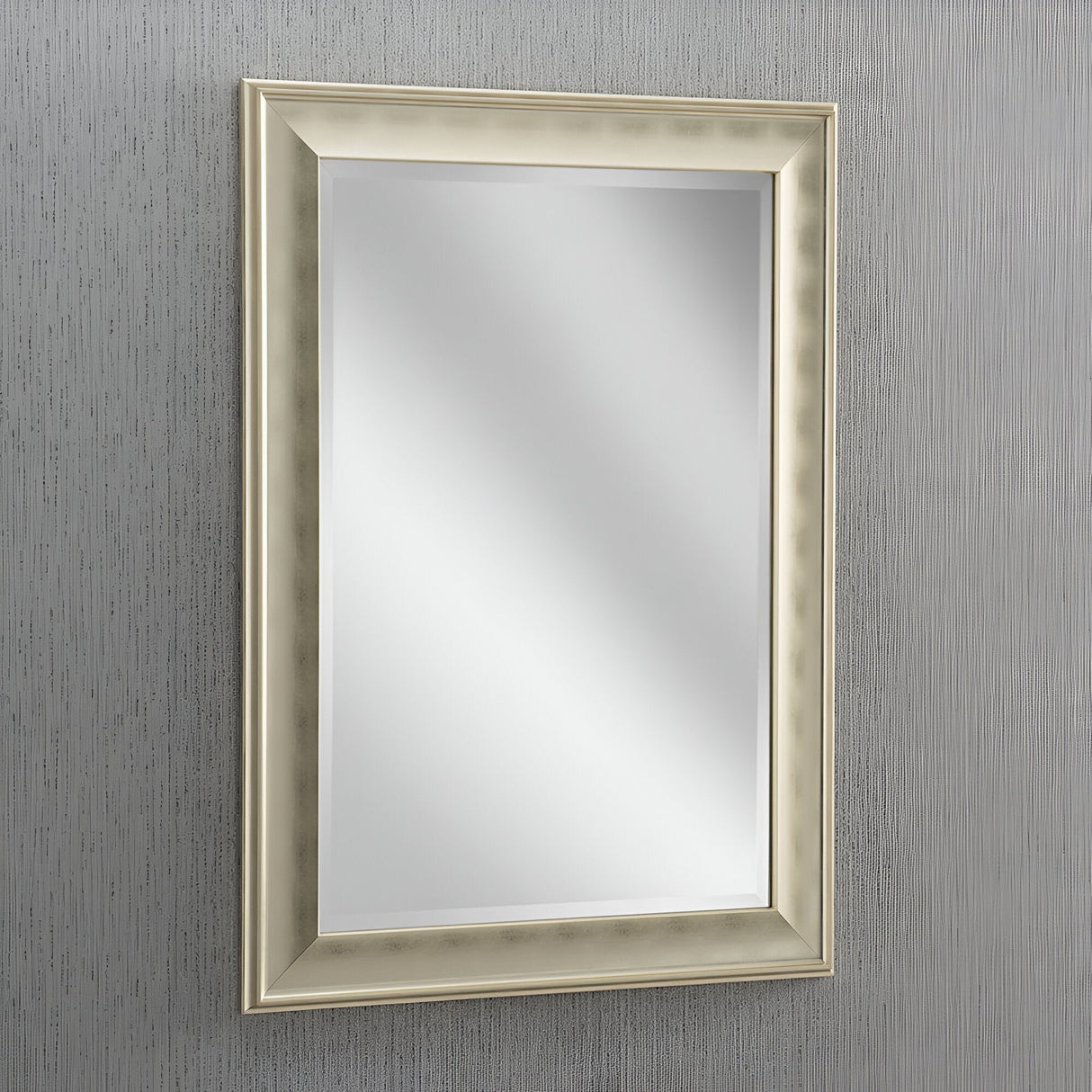 The Pulse Rectangle Wall Mirror - Champagne, with its elegant frame, complements the textured gray wall, adding a luxurious touch to the decor.