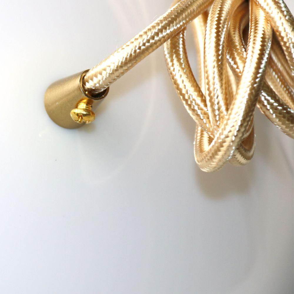 A close-up of the Arc Pendant Light in Gold & White showcases its braided gold cable with a sleek, brushed brass finish. The cable forms a loop and includes a gold connector secured with a small screw, set against a plain white background to highlight its contemporary design.