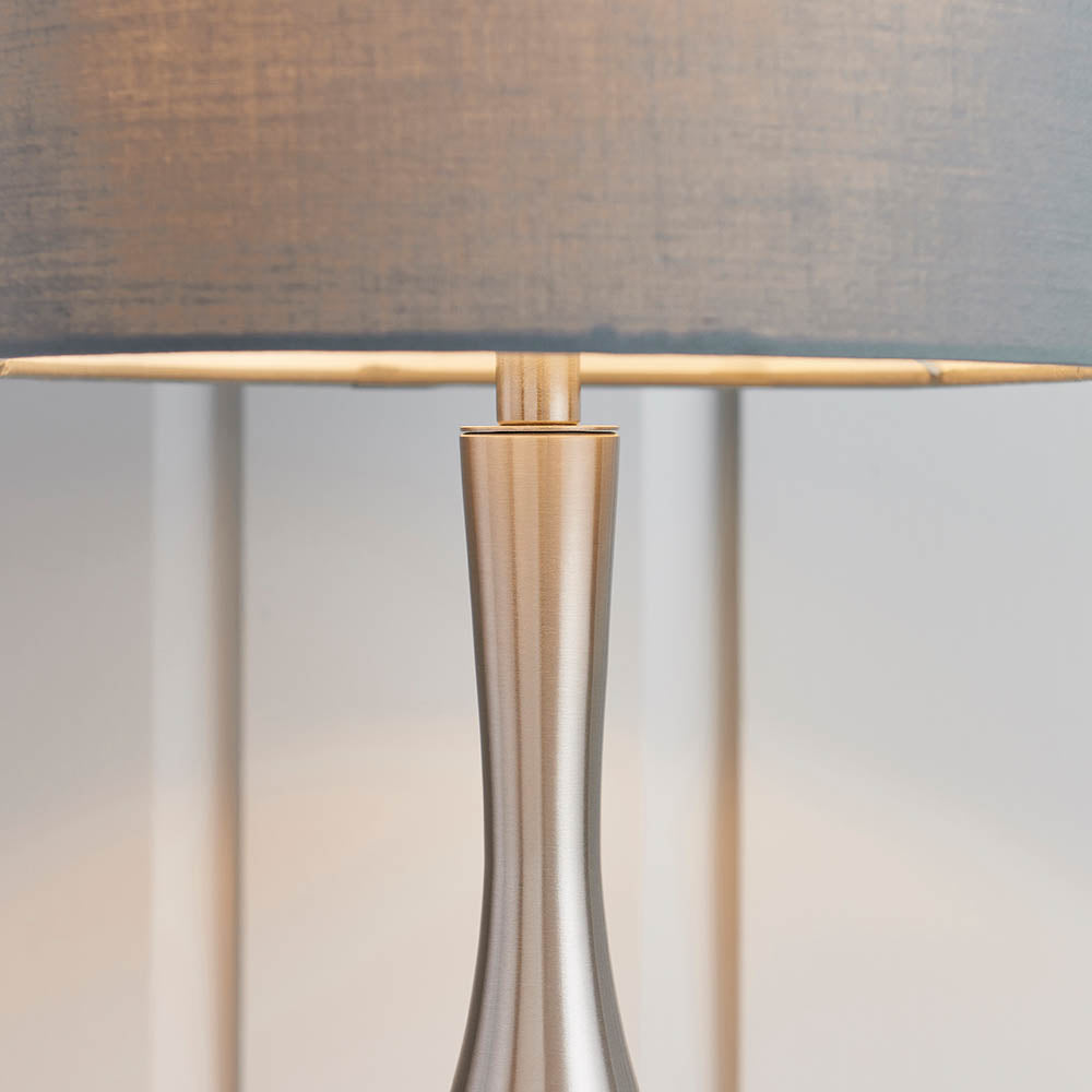 Close-up of the Endon Chartbury LED table lamp showing its slim satin nickel base and grey fabric drum shade.