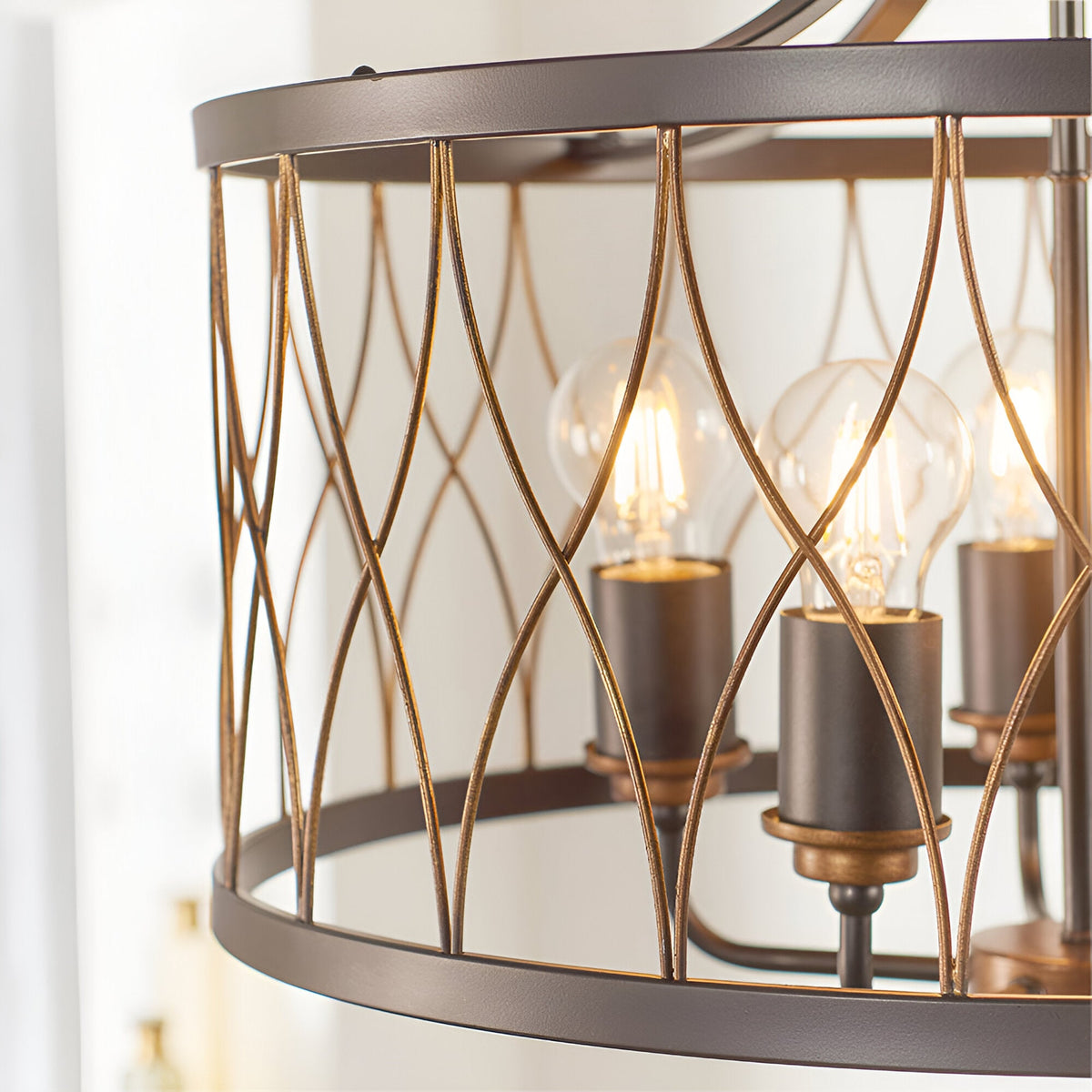 Hulton 5 Light Pendant close-up showing black and bronze lattice cage frame with exposed E27 bulbs on bronze lamp holders.
