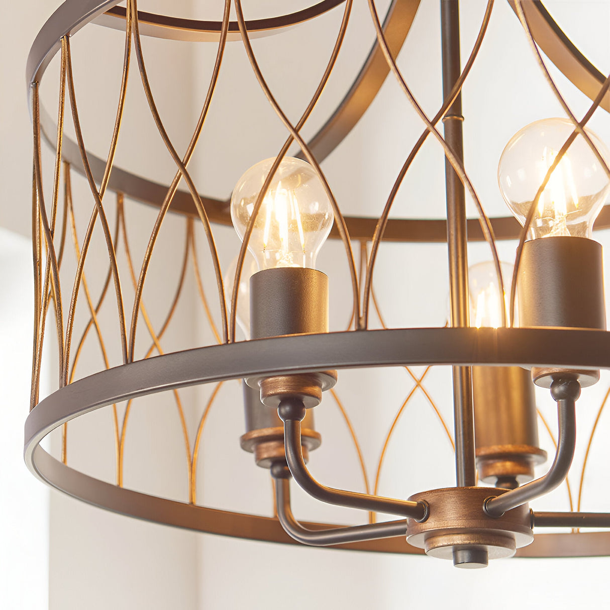 Hulton 5 Light Pendant close-up showing open lattice cage in matt black and bronze finish with exposed E27 bulbs on candle-style holders.