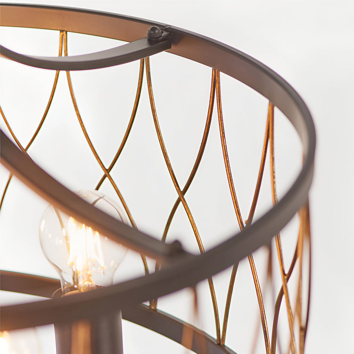 Close-up of the Hulton 5 Light Pendant, showing matt black circular frame with bronze lattice metalwork and an E27 bulb, on a plain white background.