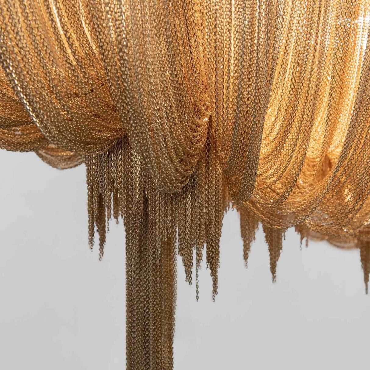 Close-up of the Mireya 8 Light Metal Chain Veil Chandelier in champagne, showing layered draped chains with an irregular fringed lower edge.