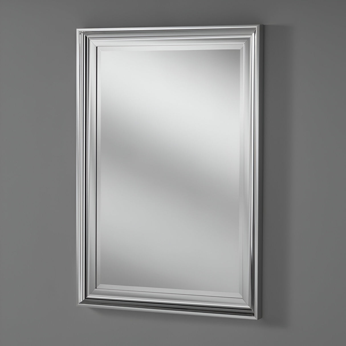 In a contemporary living space, the Wave Rectangle Wall Mirror - Silver adorns a gray wall. Its elegant detailing and clean lines subtly reflect light, enhancing the room's brightness.