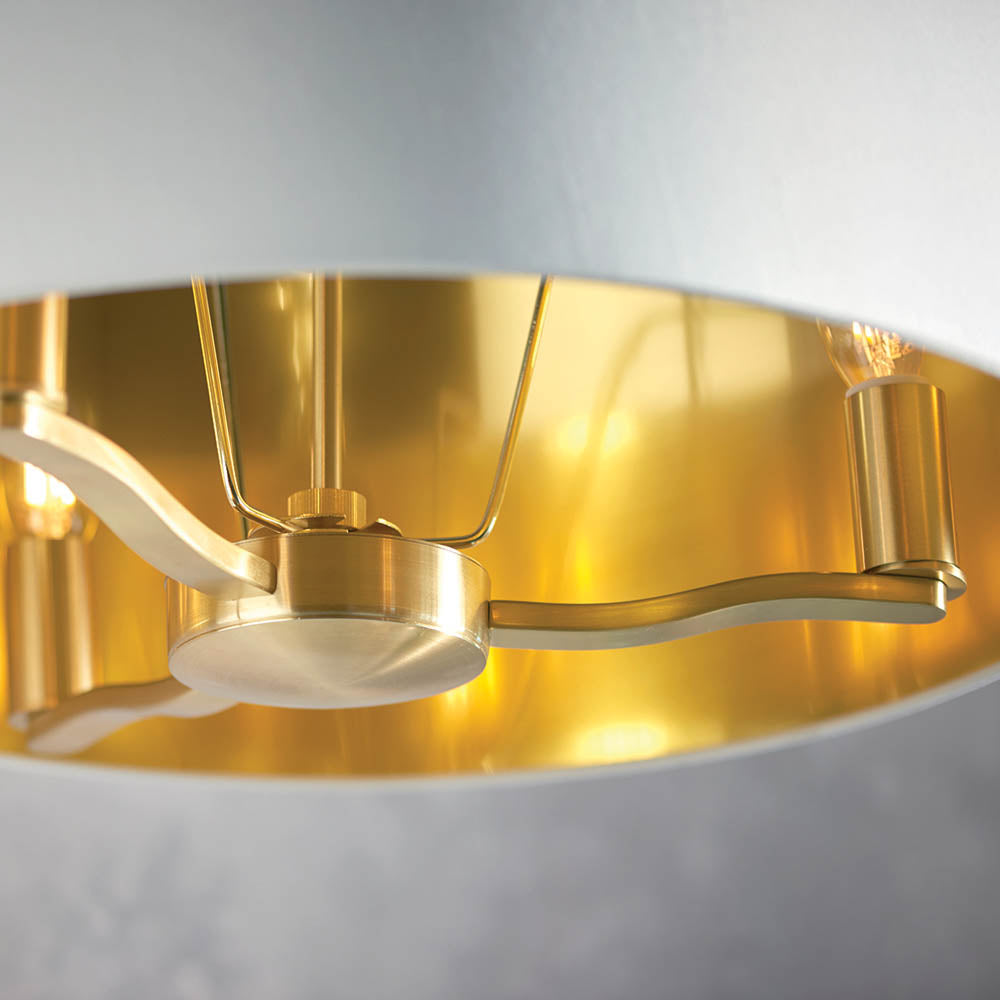 Close-up inside the Endon Brendale 3 Light Pendant showing three E14 lamp holders on brushed satin gold metalwork against the shade's metallic gold lining.