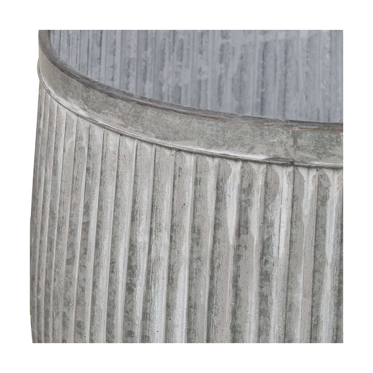 Close-up of a galvanised zinc barrel planter from the set of 2, showing ribbed vertical fluting and a rolled rim in weathered grey metal.