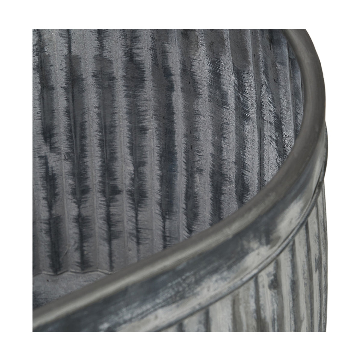 Close-up of a galvanised zinc oval planter from the set of 3, showing ribbed vertical texture and a rolled rim in weathered grey metal.