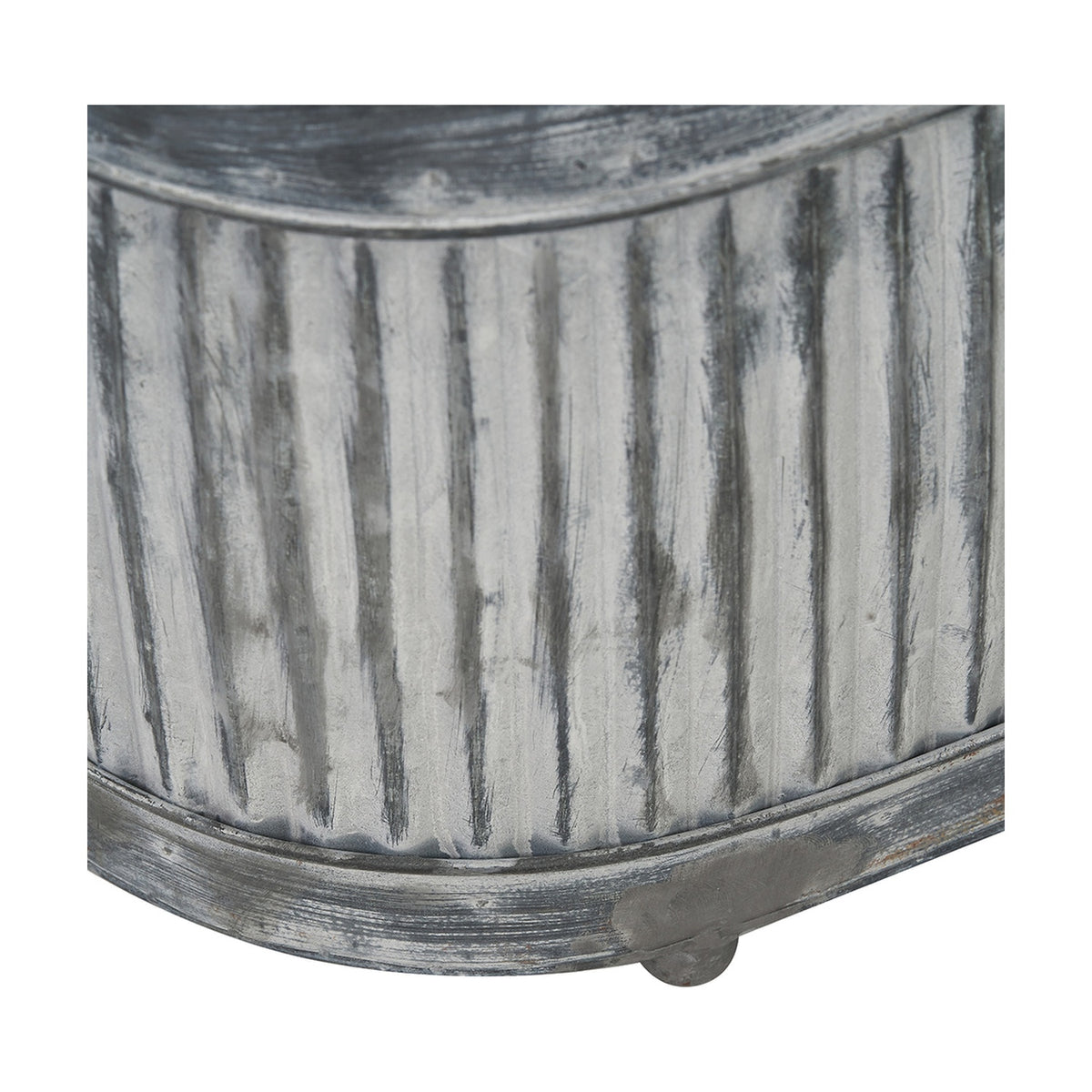 Close-up of a galvanised zinc oval planter from the Set of 3, showing ribbed vertical fluting, a rounded rim, and a small foot on a weathered grey metal finish.