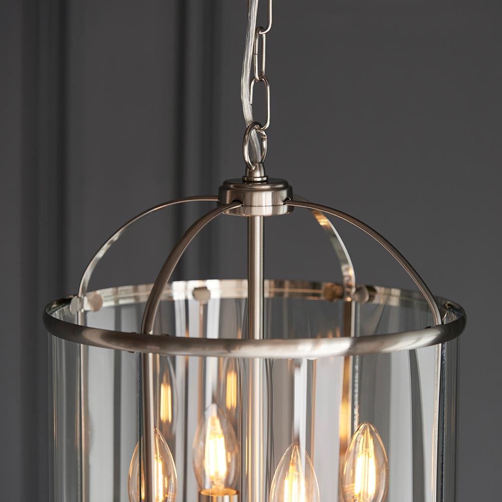 Endon Caldbury 4 light pendant in nickel with clear glass panels, four E14 candle lamps and adjustable chain, shown against a grey background.