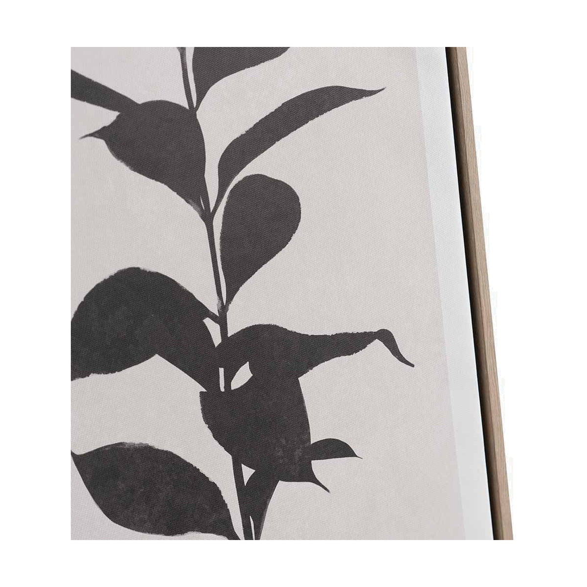 Close-up of a natural canvas wall art print with a black leaf and stem silhouette, shown in a wooden frame against a plain white background.