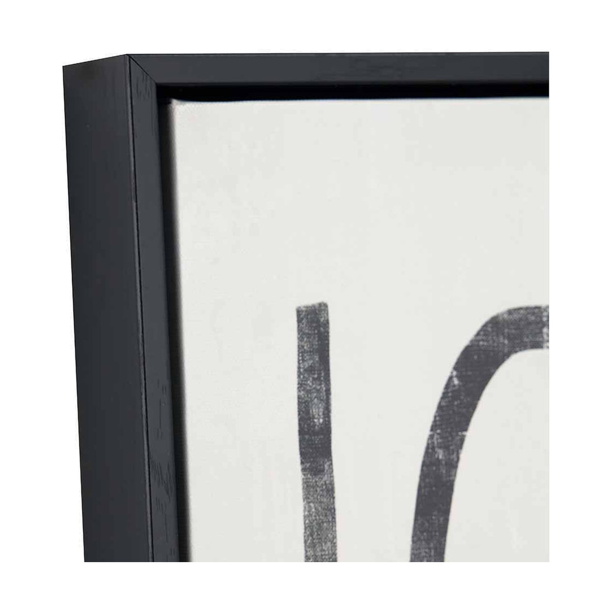 Close-up corner detail of a black-framed canvas wall art print, showing a bold black squiggle motif on white canvas within a matte black wooden frame.