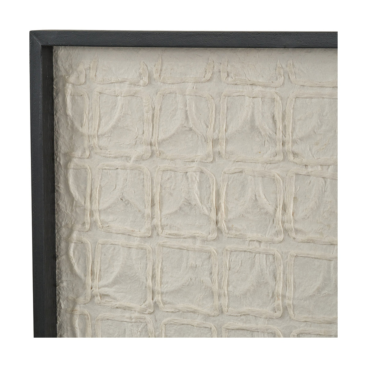 Close-up of natural paper wall art in a black wood frame, showing a raised grid pattern of textured cream fibre squares.