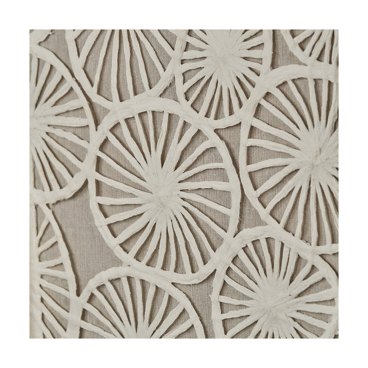 Close-up of natural paper cut-out wall art with layered wheel-shaped spoke patterns in white on a beige linen backing, part of a set of 2 framed pieces.