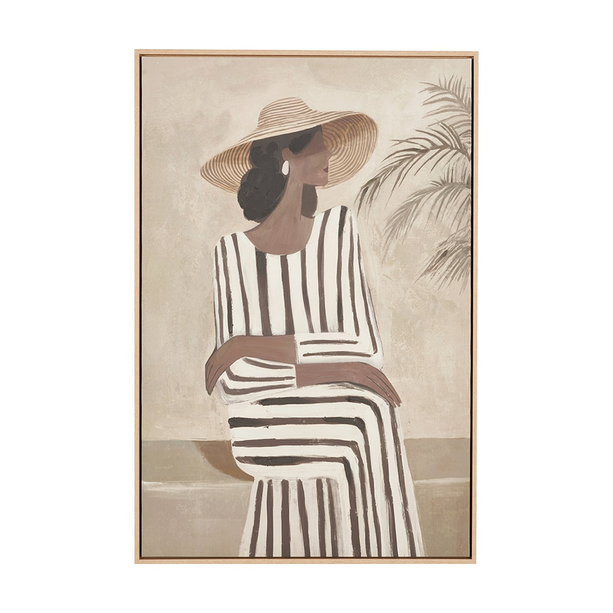 Canvas wall art in a natural wood frame depicting a woman in a wide-brimmed hat and striped dress seated beside a palm plant, on a plain background.