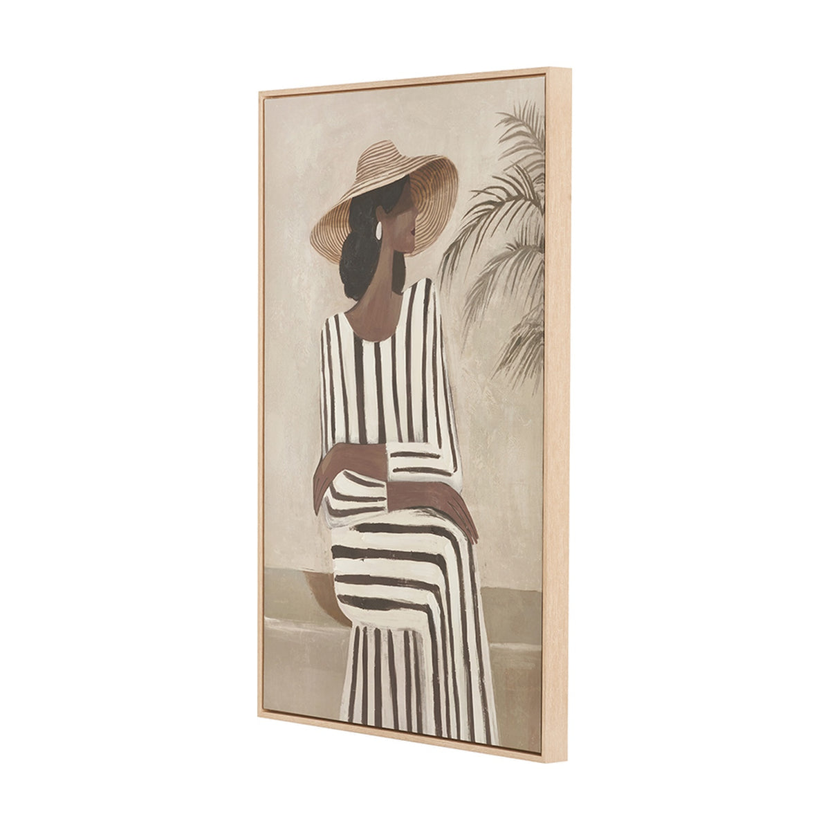 Canvas wall art in a natural wood frame, side angle view, depicting a woman in a striped dress and straw hat beside a palm plant on a neutral background.