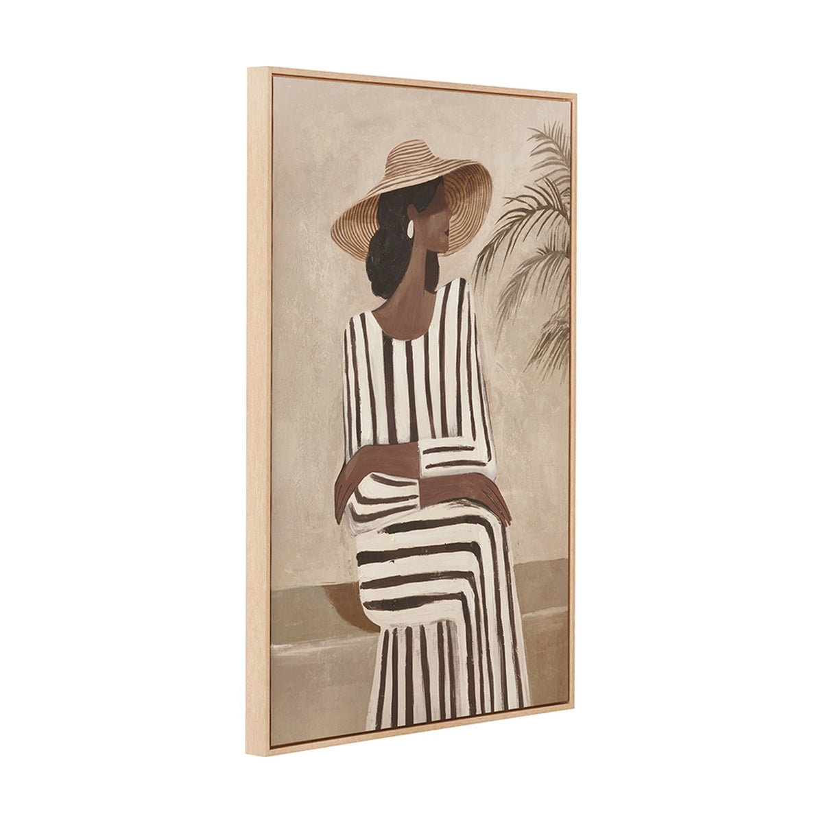 Rectangular canvas wall art in a natural wood frame, depicting a woman in a straw hat and striped dress beside a palm plant, shown at an angle on a plain white background.