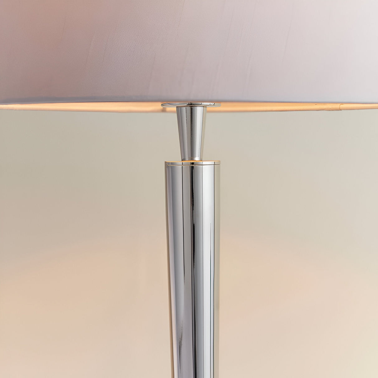 Close-up of Endon Crandale USB table lamp showing the slim bright nickel steel column and the lower edge of the mink faux silk shade.