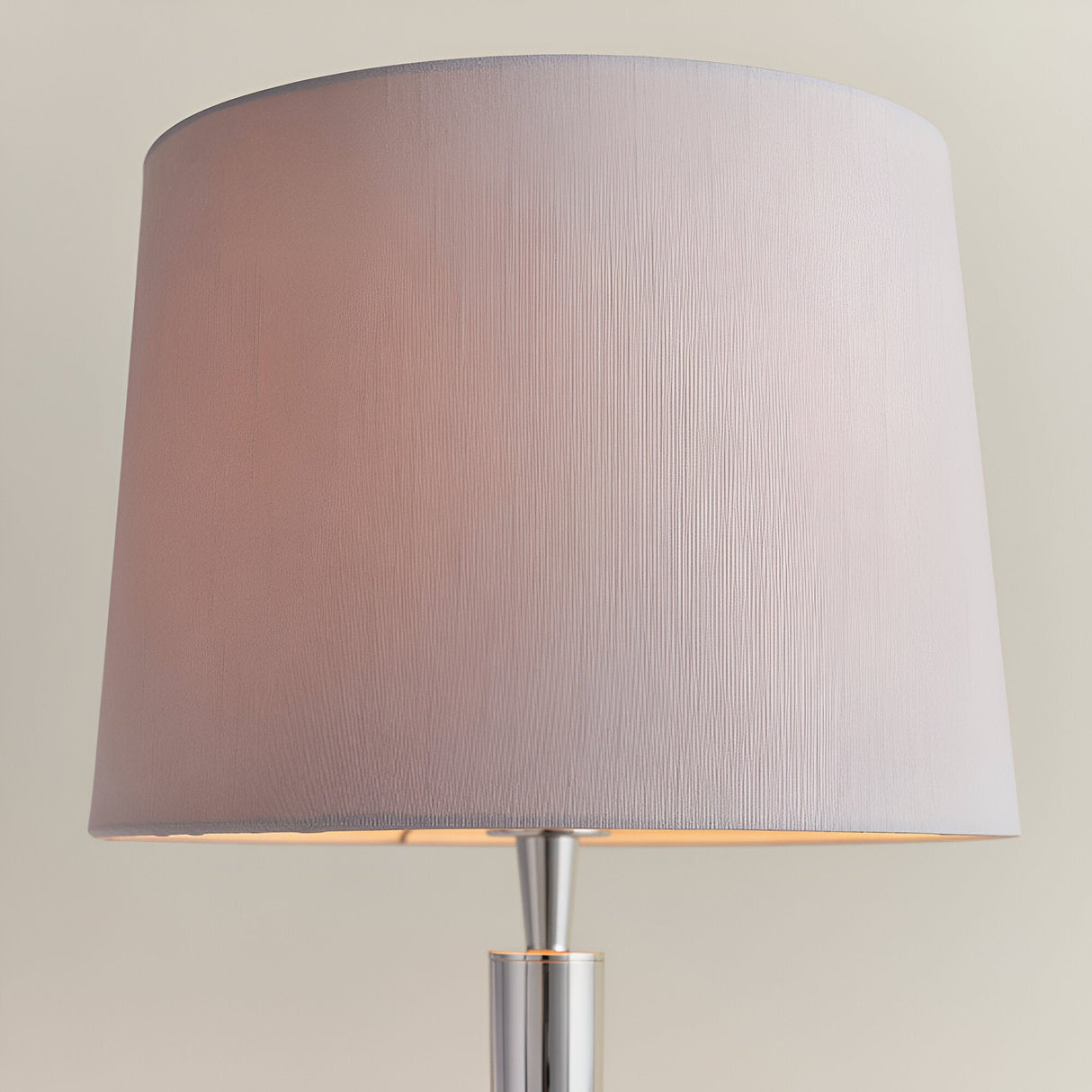Close-up of the Endon Crandale table lamp shade in mink faux silk, tapered drum shape, sitting on a slim chrome-nickel stem against a neutral background.