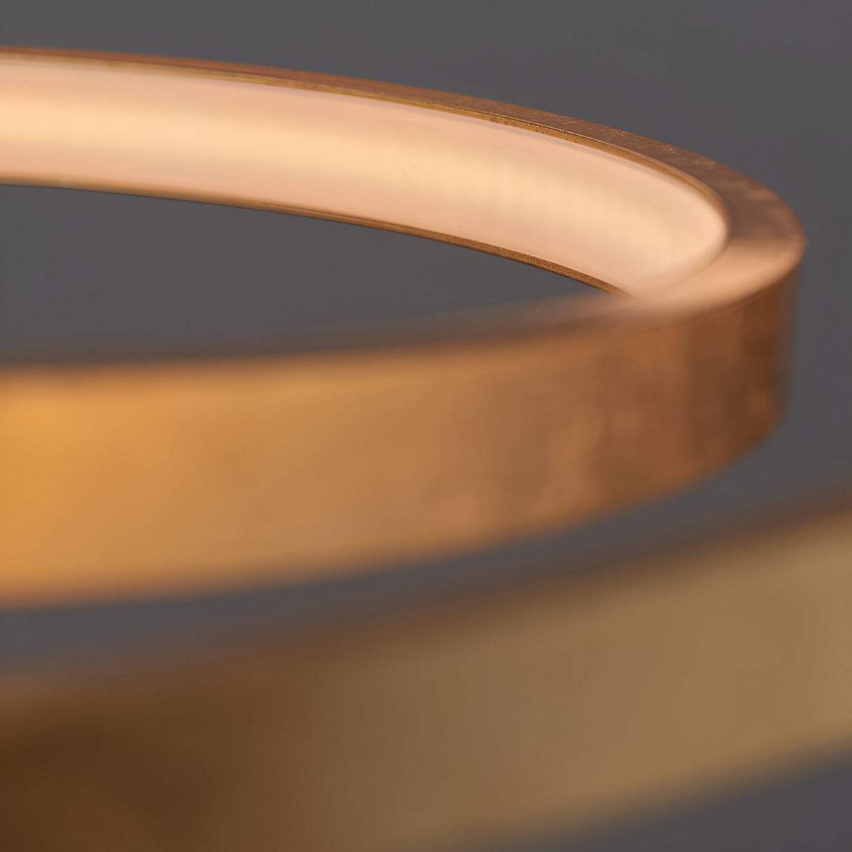 Close-up of the Endon Cliffley ring pendant showing the slim circular hoop with integrated LED strip and warm gold leaf finish.