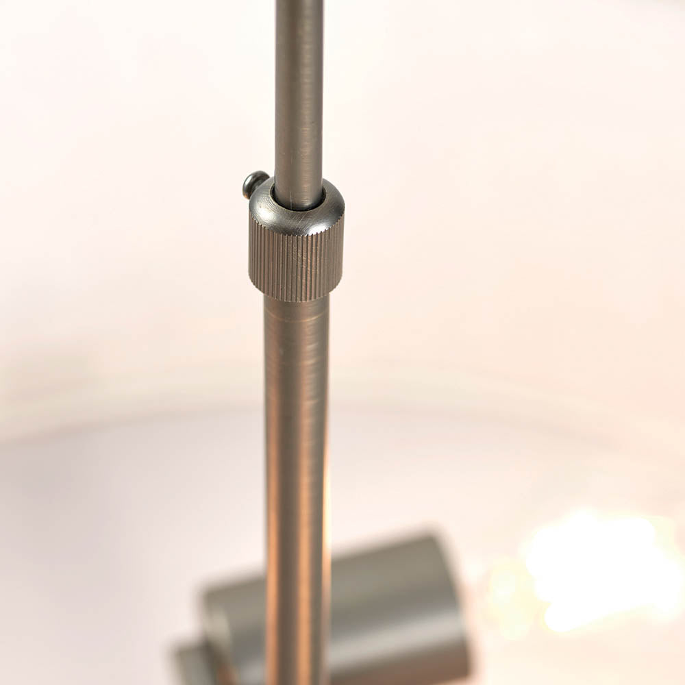 Close-up of the Brendon 3 Light Pendant's bronze telescopic stem with a knurled adjustable collar, shown against a softly lit fabric shade.