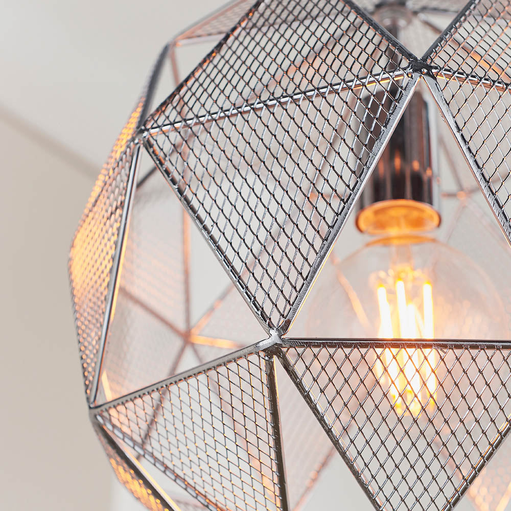 Aldford Pendant in polished chrome, close-up of the geometric mesh triangle shade with visible E27 filament bulb inside.