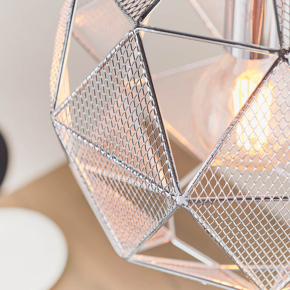 Close-up of the Aldford Pendant in polished chrome, showing its geometric mesh triangle shade and glowing bulb inside.