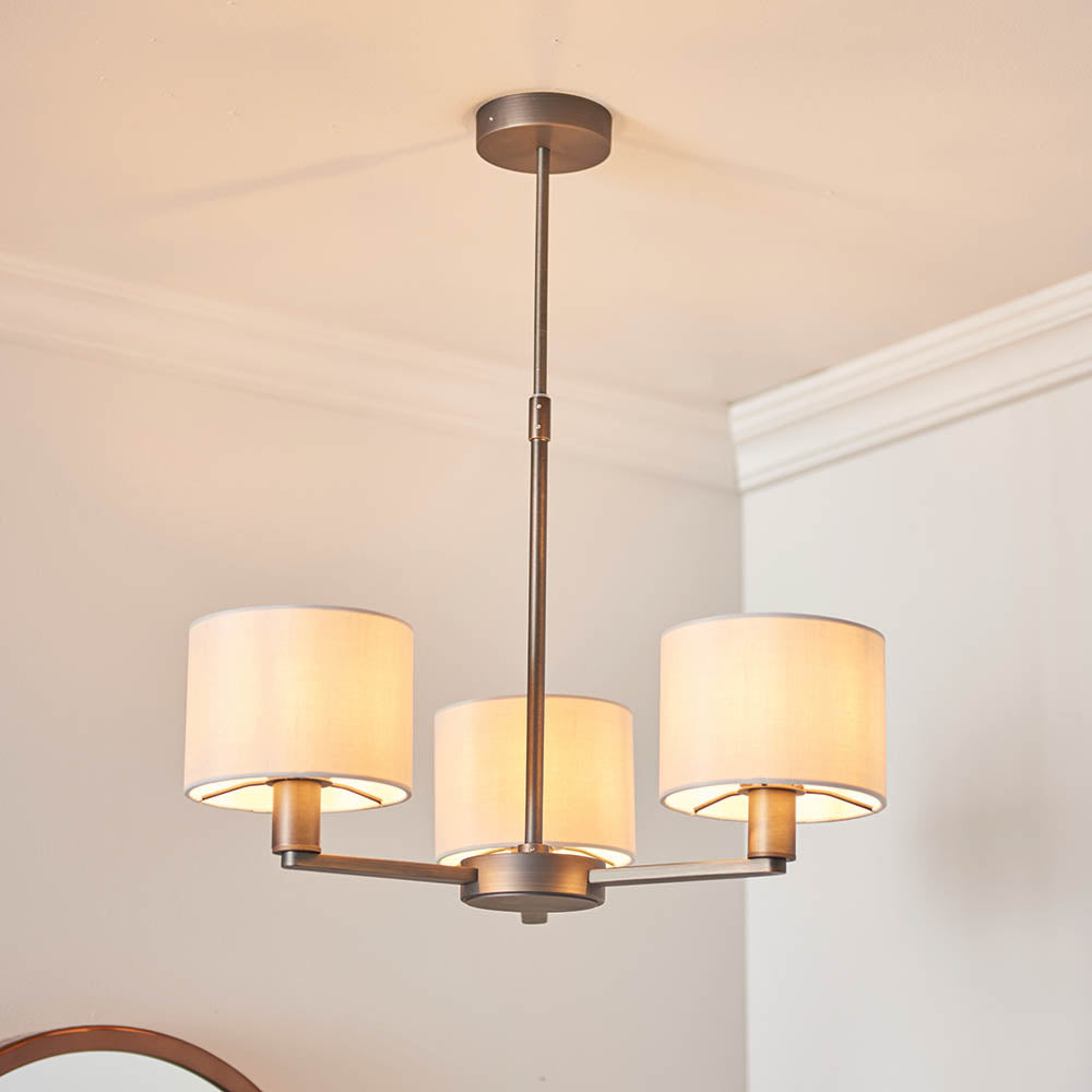 Endon Bexley 3 Light Pendant in antique bronze with three marble-effect faux silk shades on curved arms, mounted to a white ceiling.