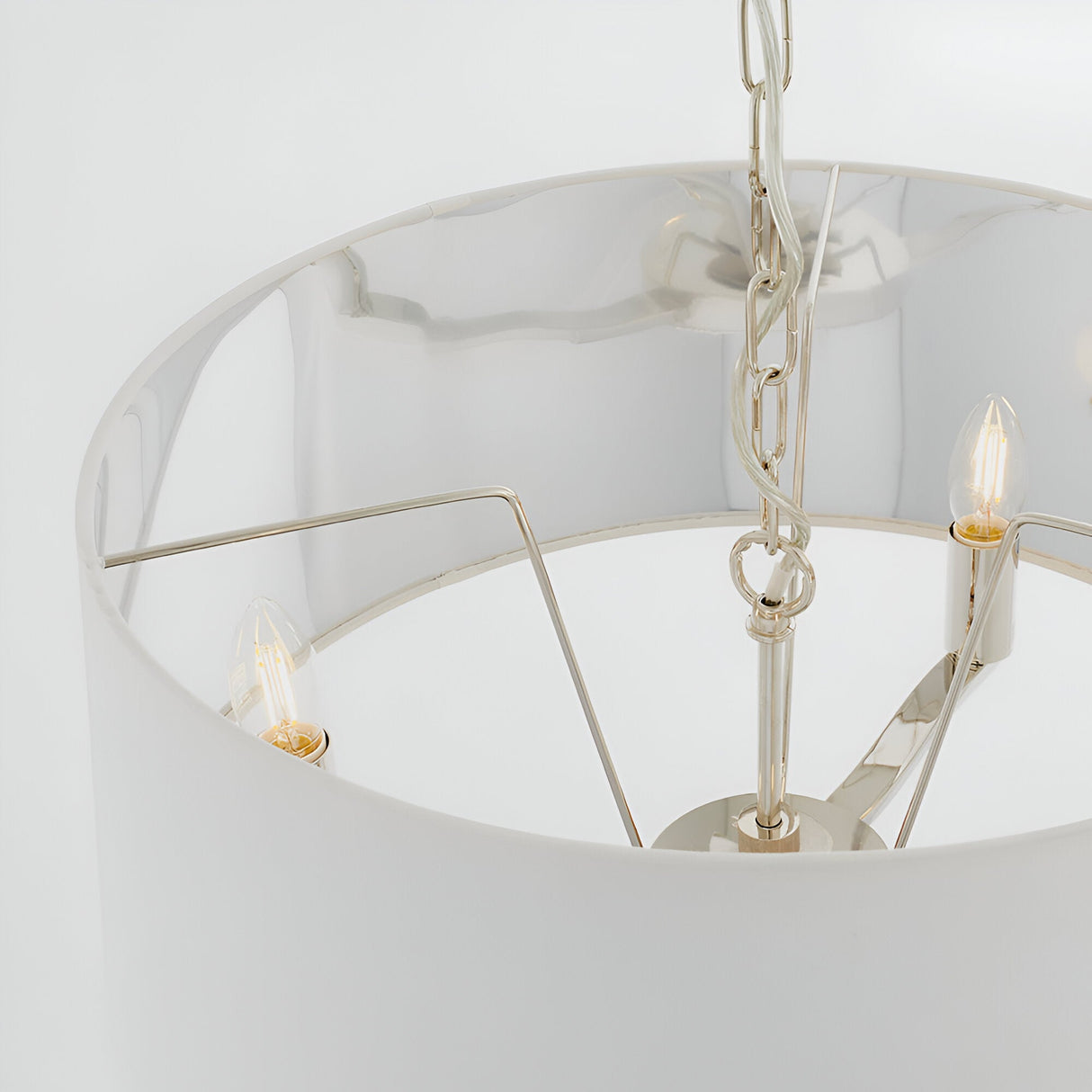 Close-up of Endon Brendale 3 light pendant showing nickel metalwork, three E14 lamps and white faux silk shade with metallic silver lining.