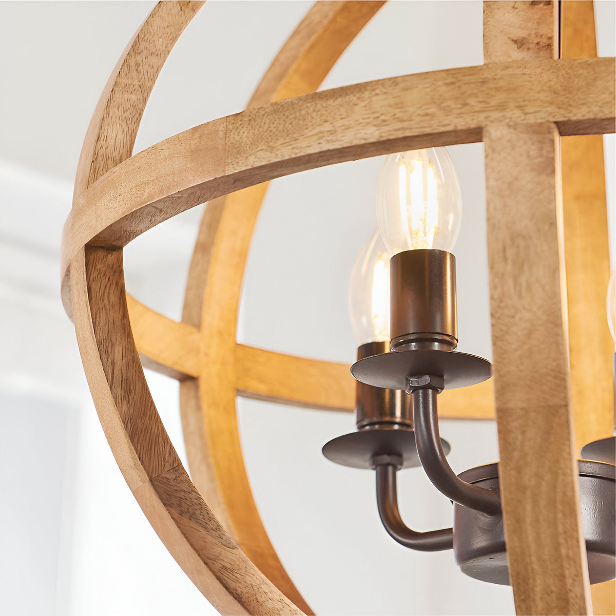 Cranleigh 4 Light Pendant close-up showing natural mango wood globe hoops and bronze E14 candle fittings with visible bulbs.