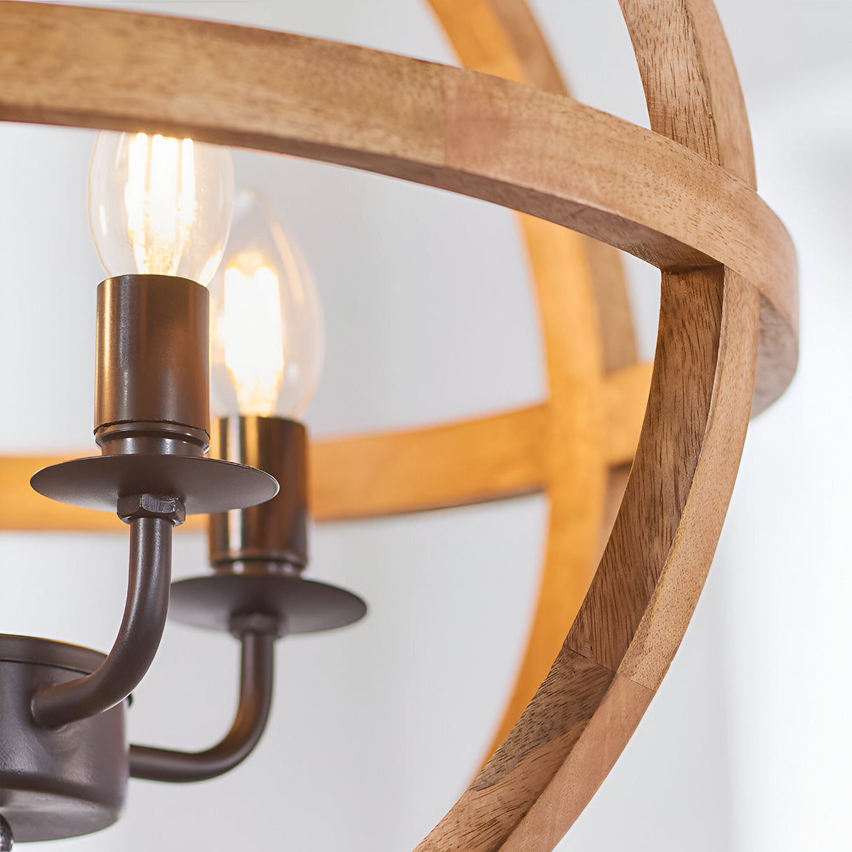 Cranleigh 4 Light Pendant close-up showing bronze fittings with E14 bulbs framed by natural mango wood hoops on a white background.