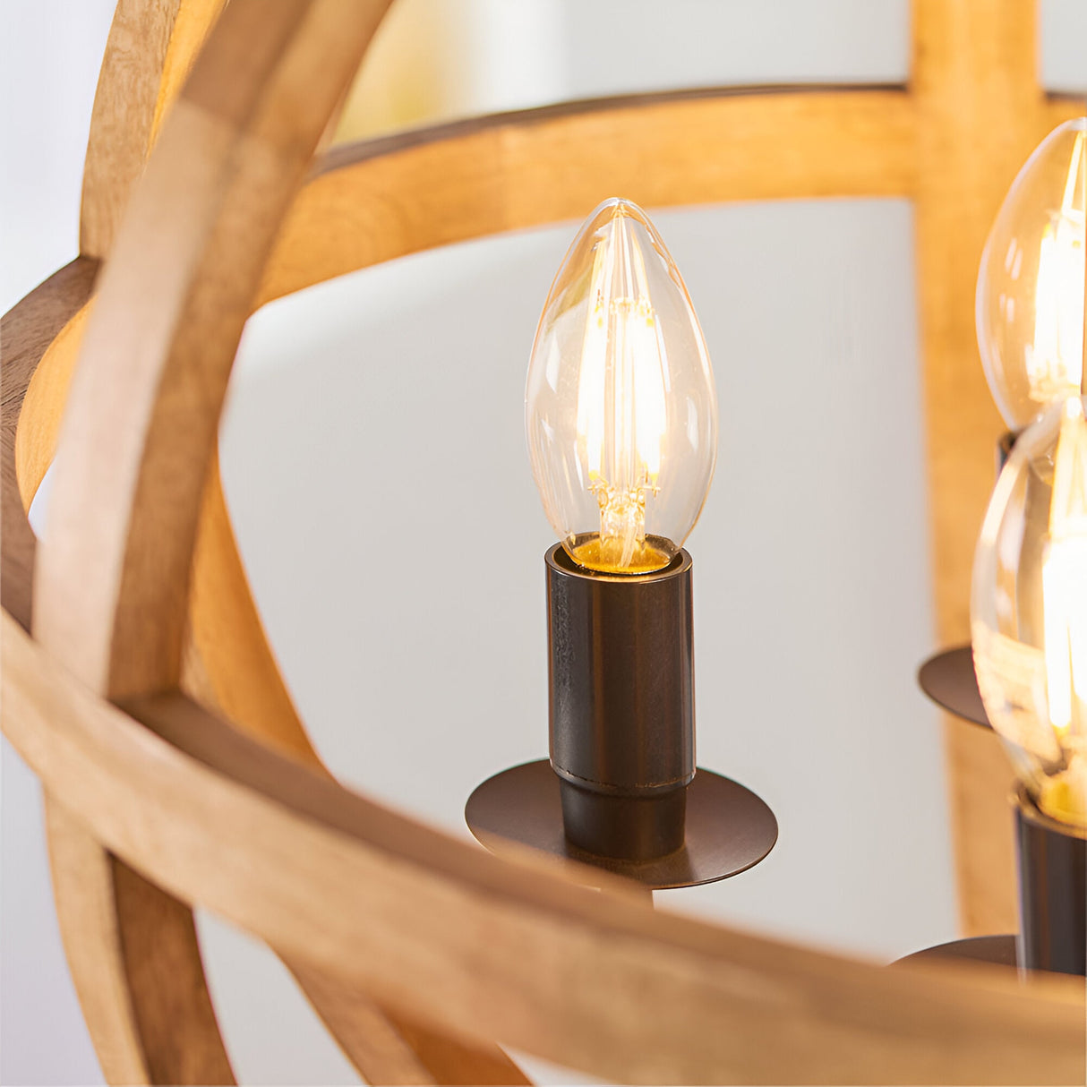 Cranleigh 4 Light Pendant close-up showing natural mango wood hoops and a dark bronze E14 lampholder with visible bulb.