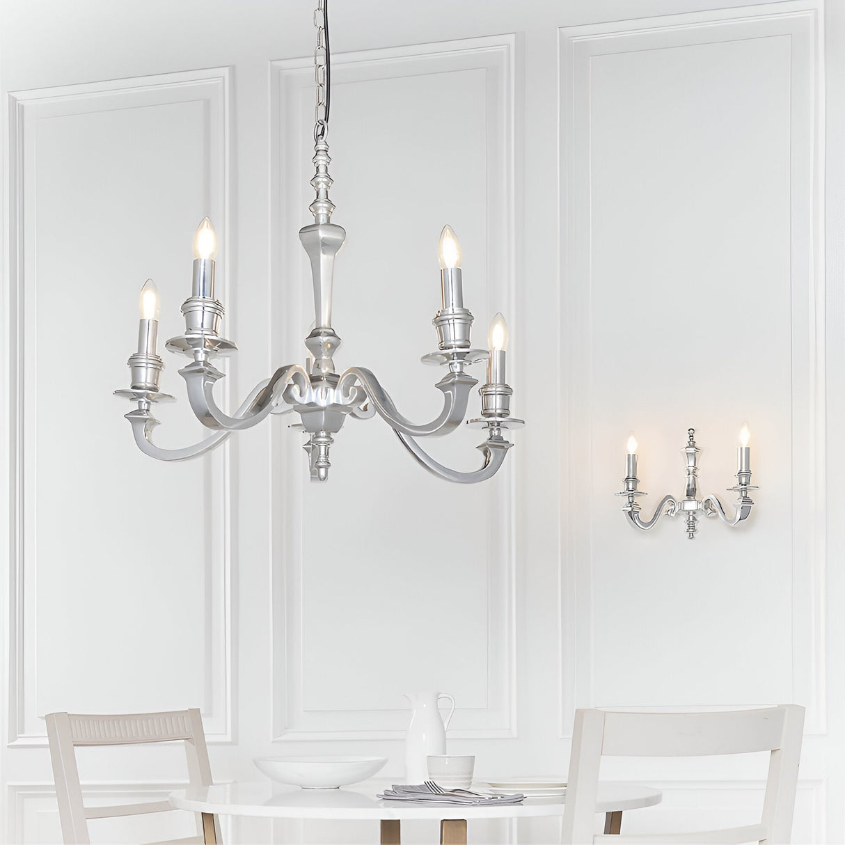 Endon Brambourne 5 light pendant in polished aluminium with curved candelabra arms, shown above a dining table with a matching wall light.