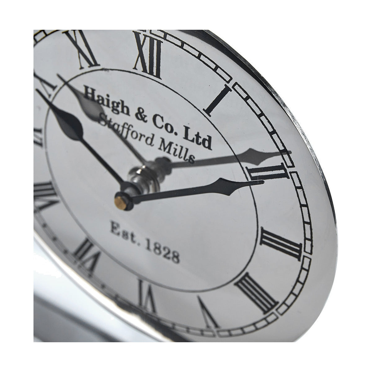 Close-up of the Silver Metal & Glass Floating Clock Face Table Clock, showing Roman numerals, black hands, and "Haigh & Co. Ltd" text on a white dial with silver rim.