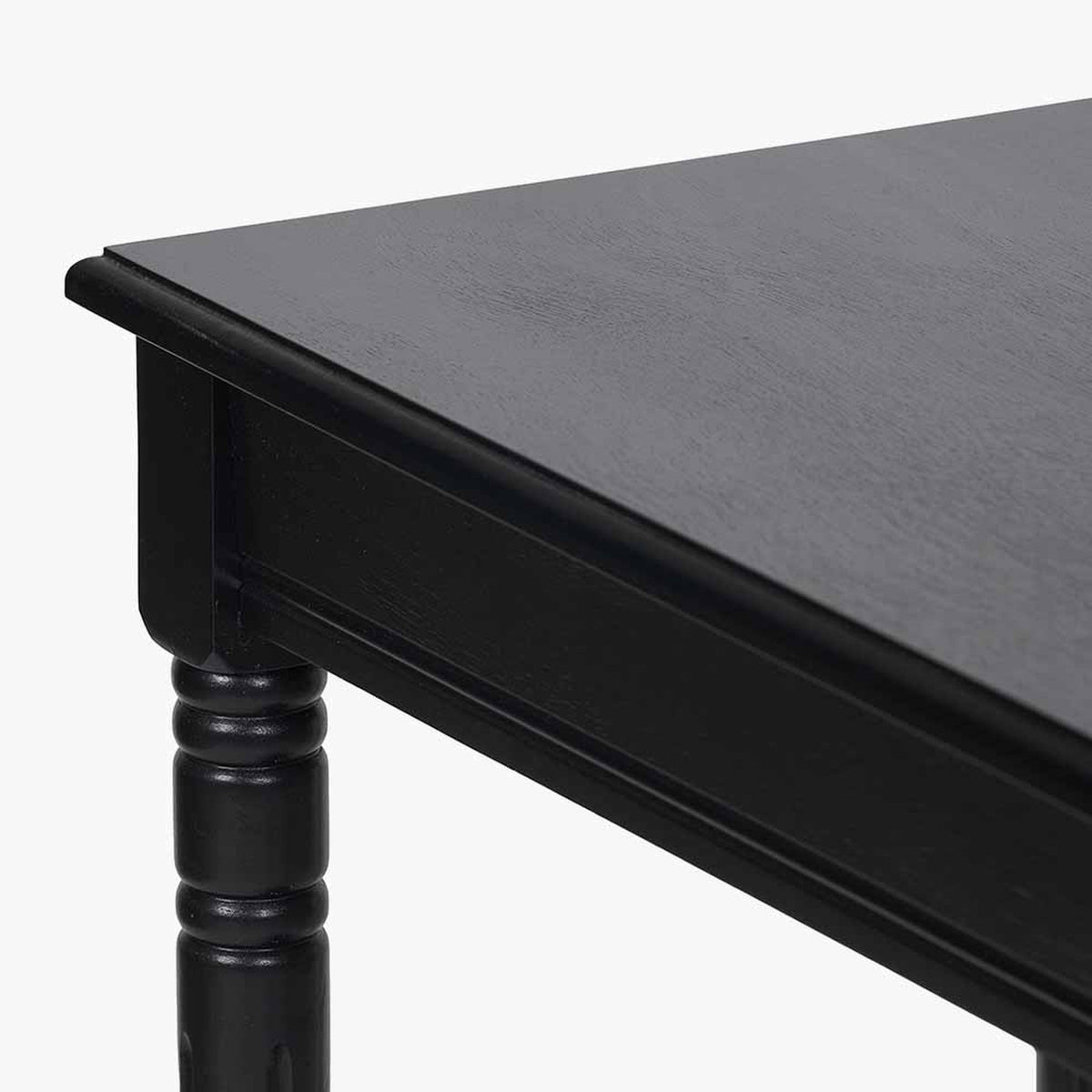Close-up of the Heritage Black Pine Console Table, 80cm, showing the black-finished wood corner, turned leg detail, and moulded edge on a plain white background.
