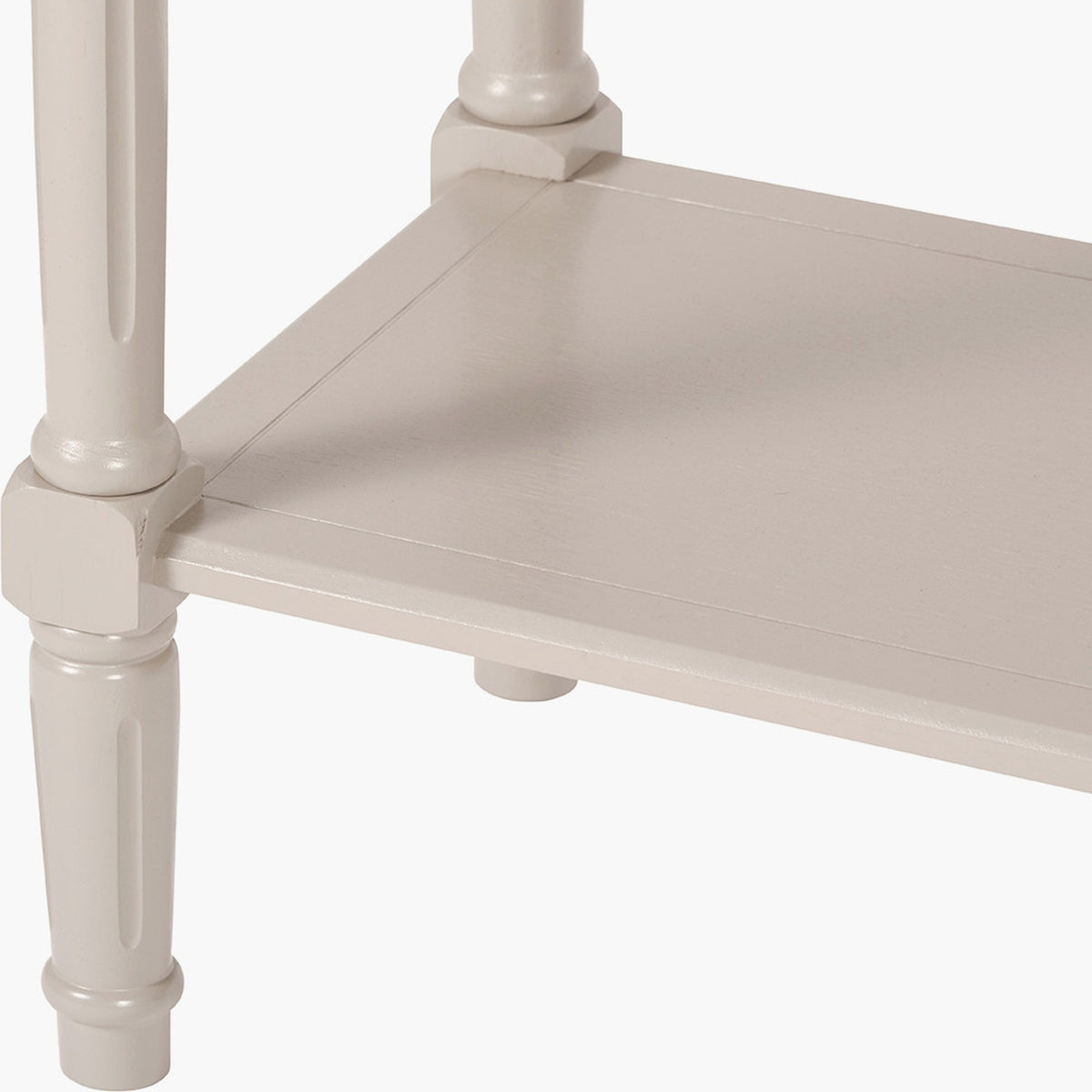 Close-up of the Heritage Putty Pine Console Table's turned wooden legs and shelf joinery in a putty cream finish, on a plain white background.