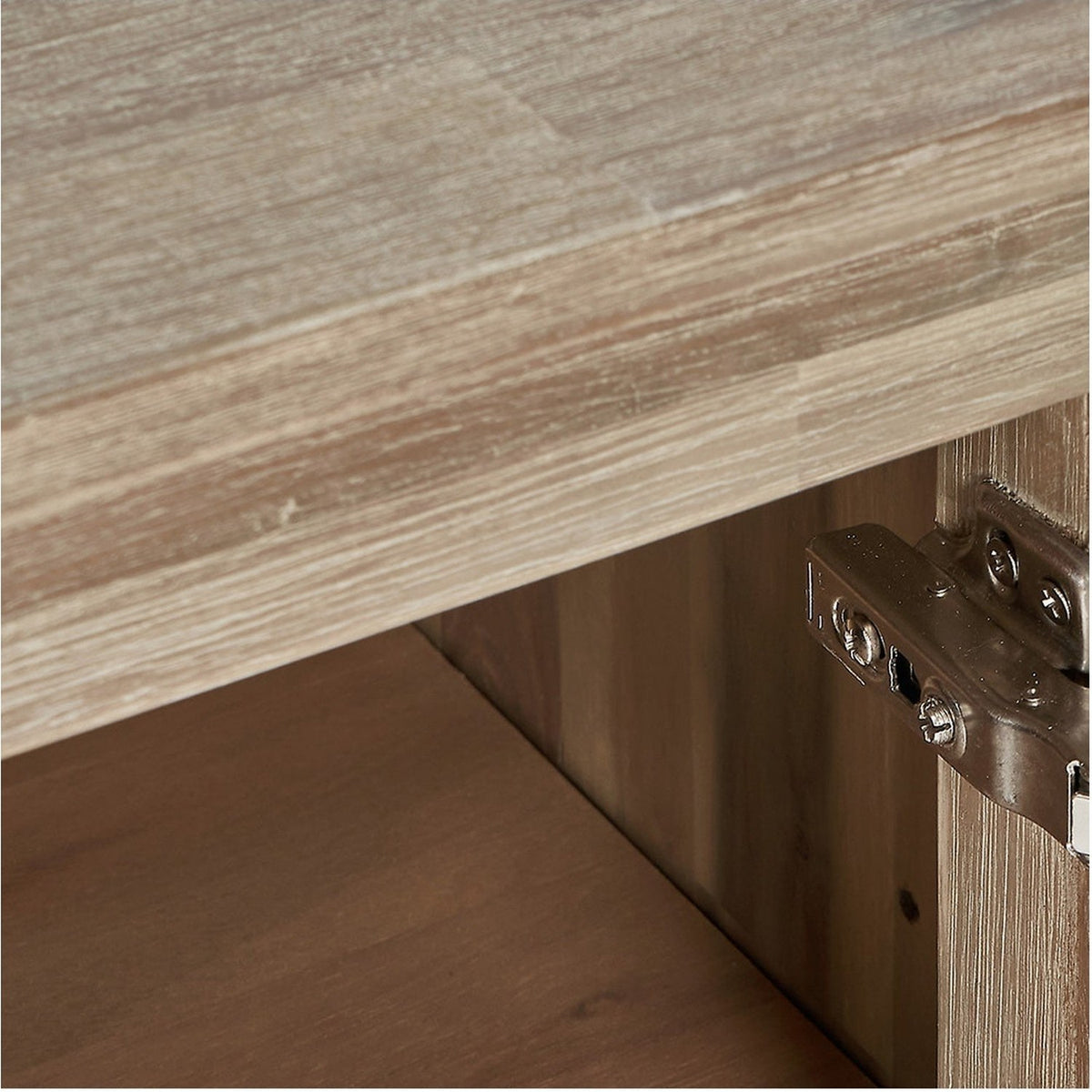 Close-up of the Marca sideboard's sand wash acacia wood top edge and black iron door hinge against the wood door front.