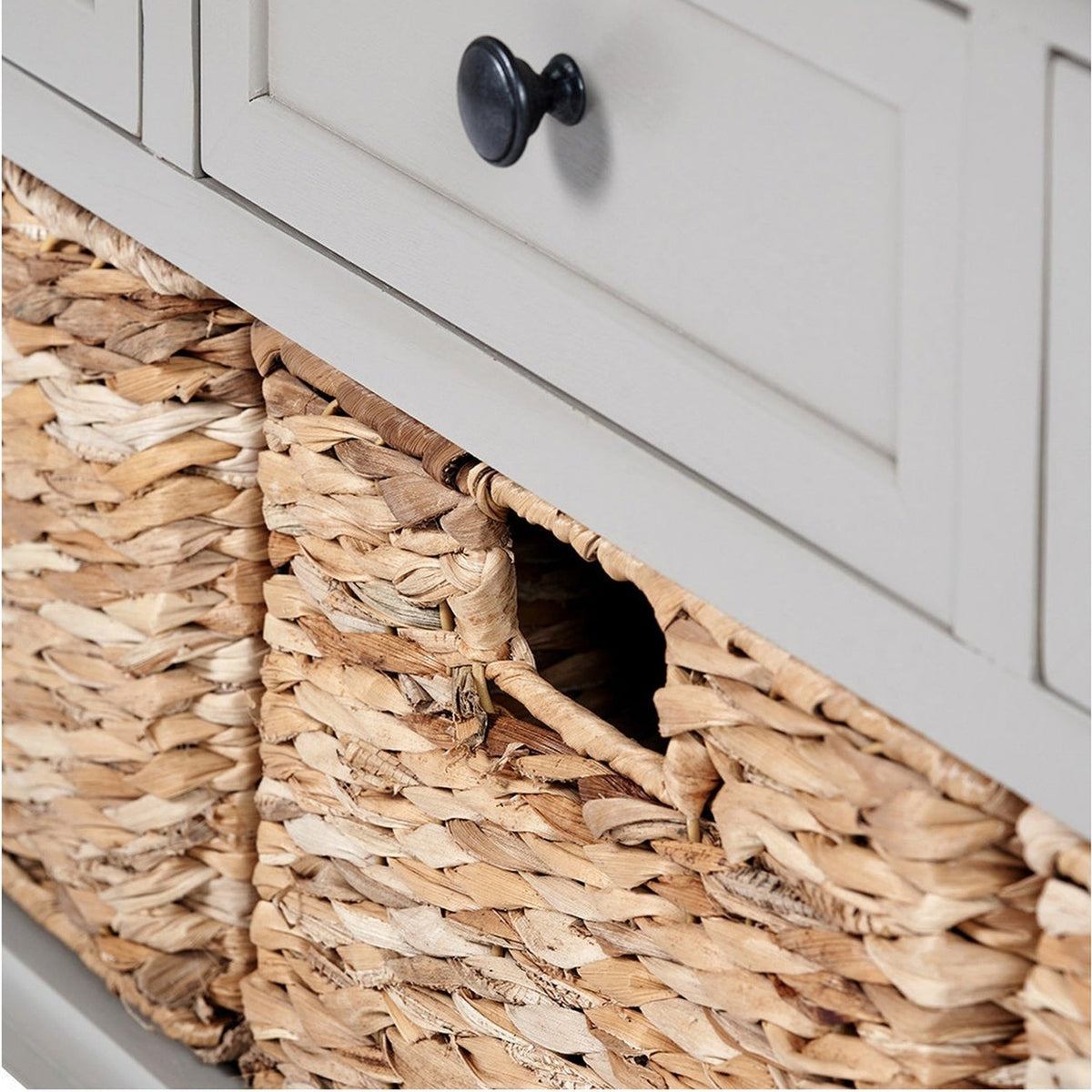 Close-up of the Devonshire Putty Pine 3 Drawer Basket Unit Sideboard, showing a woven wicker basket beneath a putty-painted drawer with a round black knob.