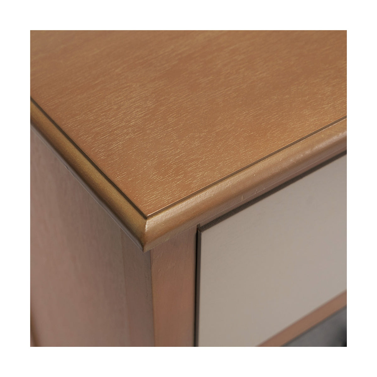 Close-up of the Loft Sage chest of drawers corner, showing a wood-grain top edge with rounded moulding above a pale drawer front and green side panel.
