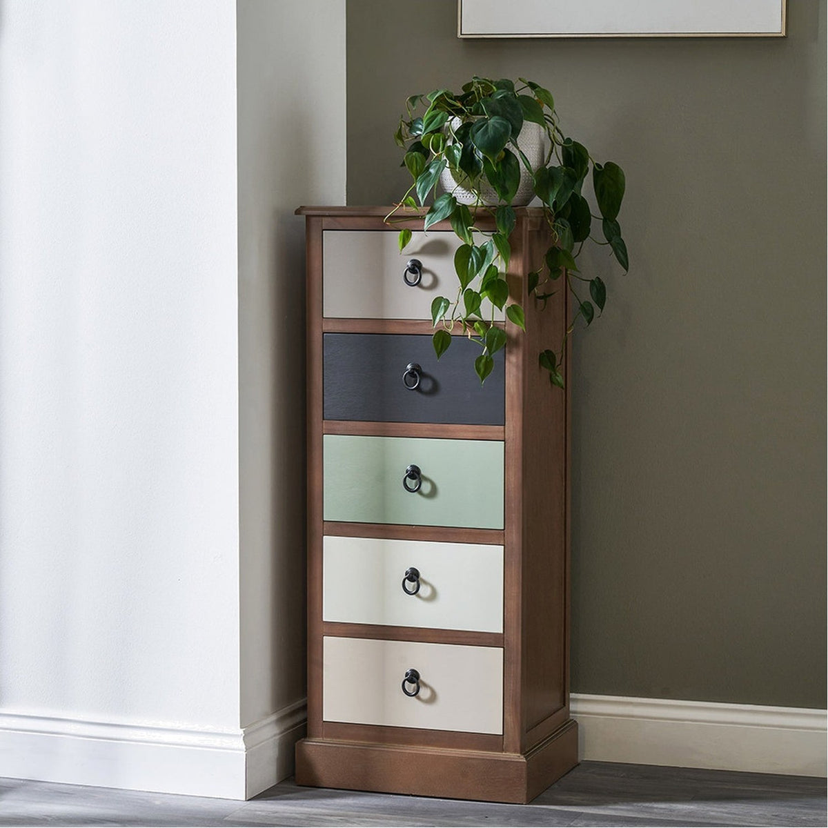 Loft Sage multicoloured pine 5-drawer unit, 101cm tall narrow chest with beige, black, green and cream fronts, ring pulls, and wooden frame, styled with a trailing plant on top.