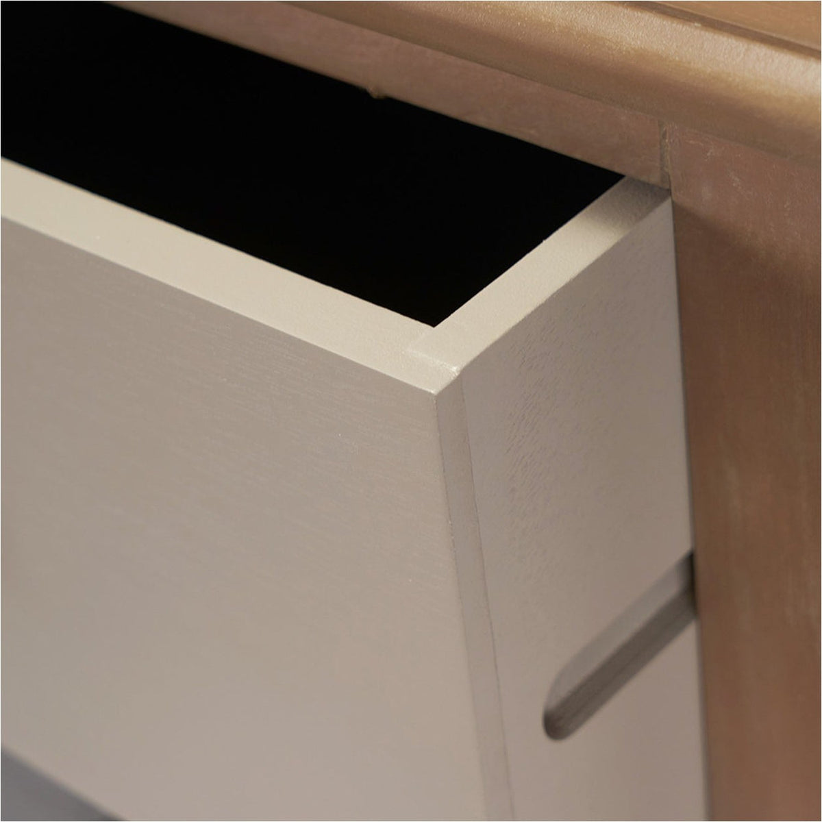 Close-up of the Loft Sage Multicoloured Pine 5 Drawer Unit, showing an open drawer in pale sage with a recessed handle groove against a wooden frame.