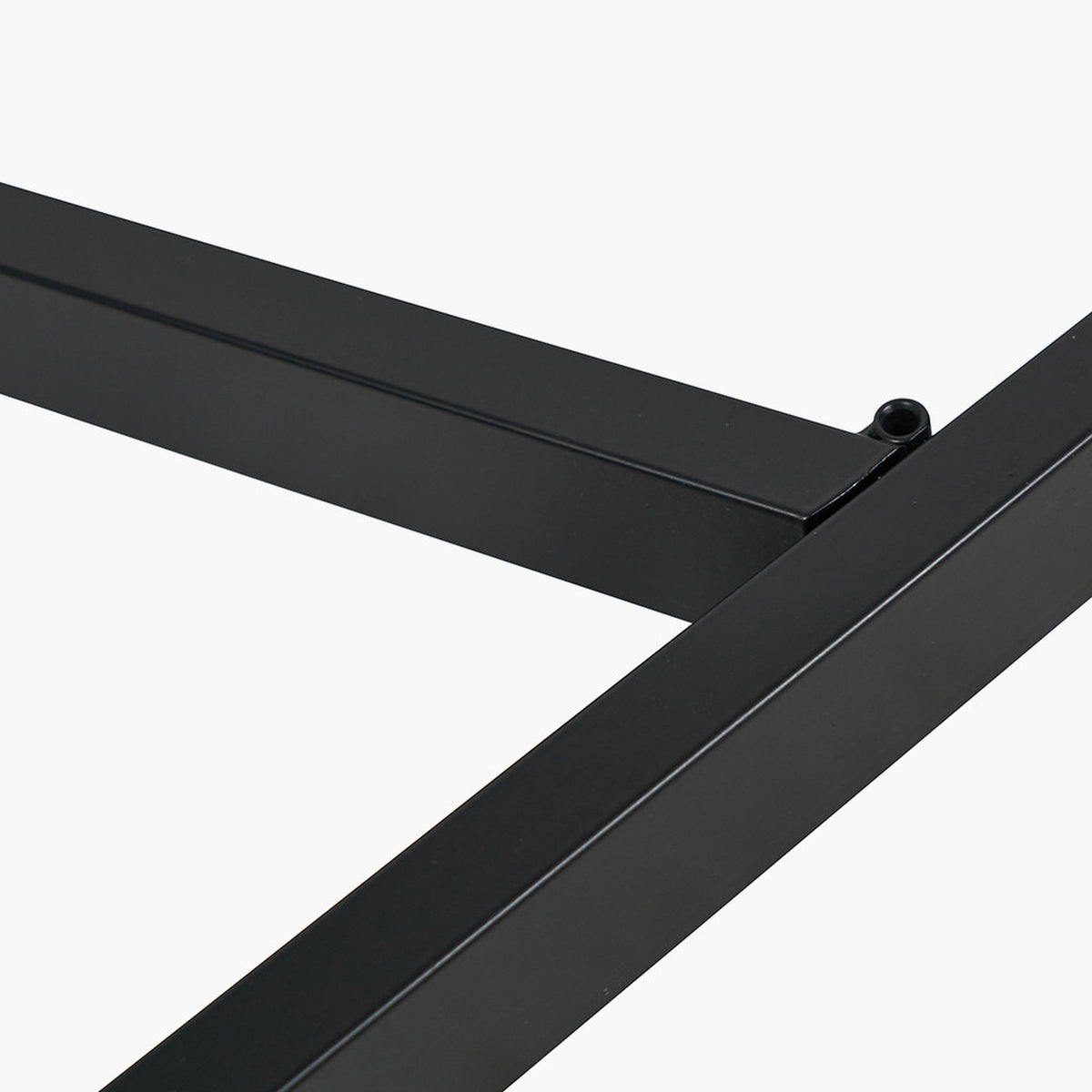 Close-up of the Ukiah dining table's black iron frame joint with grey oak veneer edge visible, shown against a plain white background.