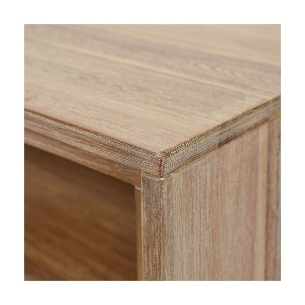 Close-up of the Marca Sand Wash Acacia shelving unit's corner joinery, showing the wood grain, sand-washed finish, and clean edge detailing.