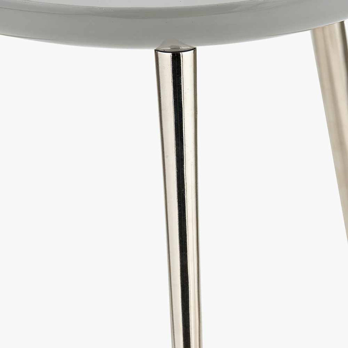 Close-up of the Seline side table's tapered silver aluminium leg meeting the grey enamel tabletop edge, shown against a plain white background.