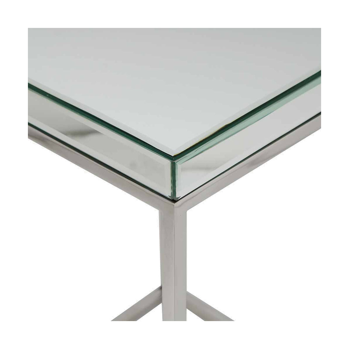 Close-up of the Elysee console table's corner, showing a mirrored glass top edge meeting a silver metal X-frame leg, on a plain white background.