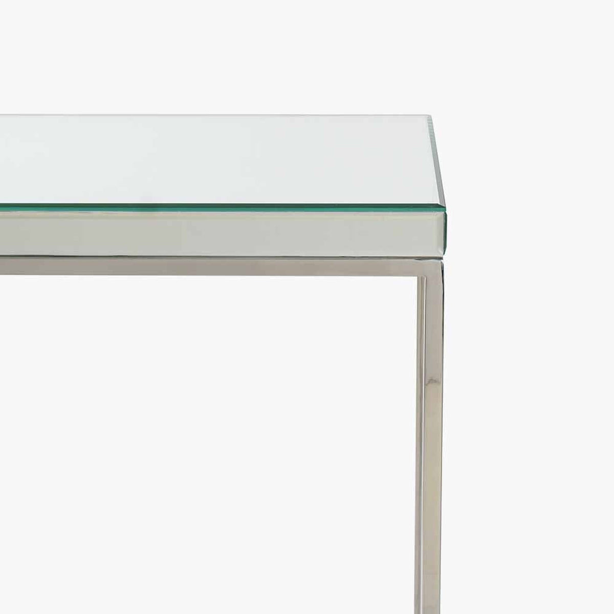 Close-up of the Elysee console table's corner, showing a mirrored glass top with bevelled edge on a silver metal frame, against a plain white background.