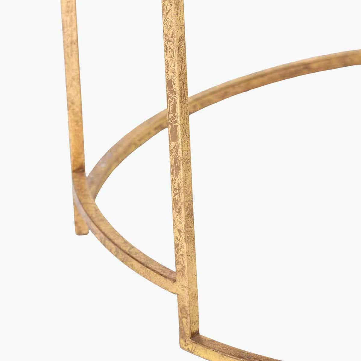 Close-up of the Veneziano coffee table's antique gold iron frame, showing curved and straight leg supports with a textured metallic finish on a plain white background.