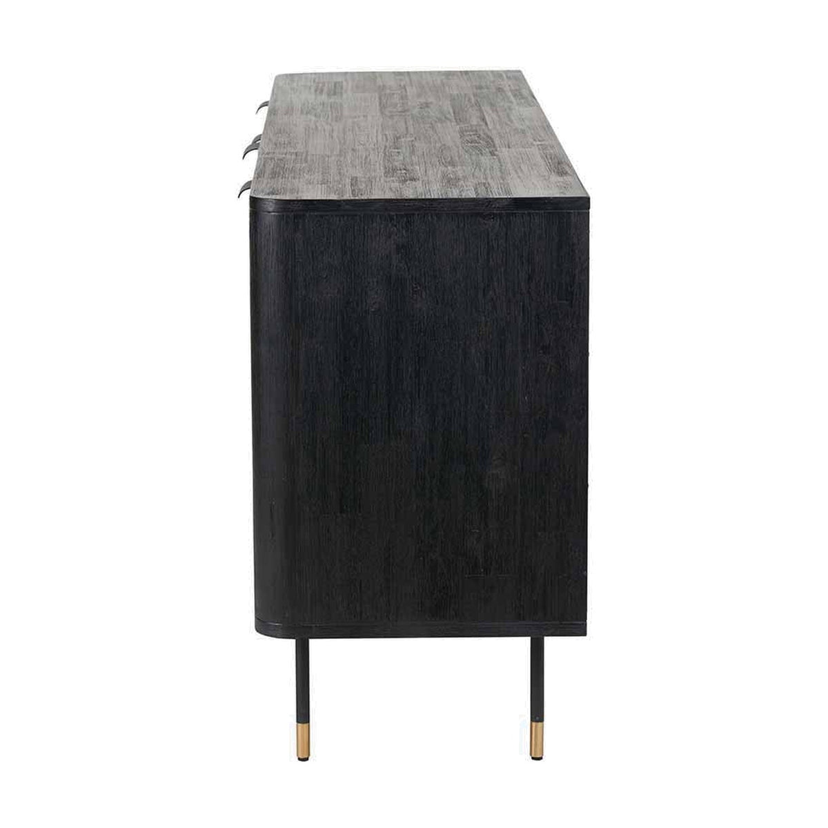 Side view of the Fiji Black Acacia & Rattan 4 Door Sideboard, showing its black wood body, textured grey-toned top with overhang, and slim tapered legs with brass feet on a white background.