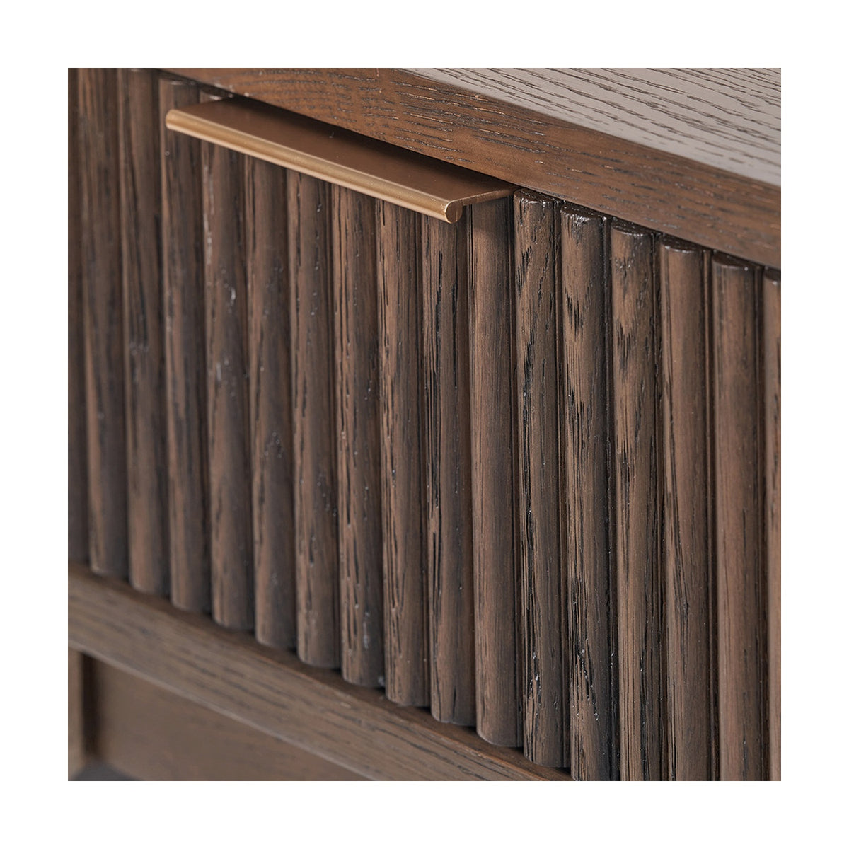 Close-up of the Raie Dark Brown Ribbed Oak & Pine 1 Drawer Unit, showing vertical fluted drawer front with a brass bar handle and wood-grain top edge.