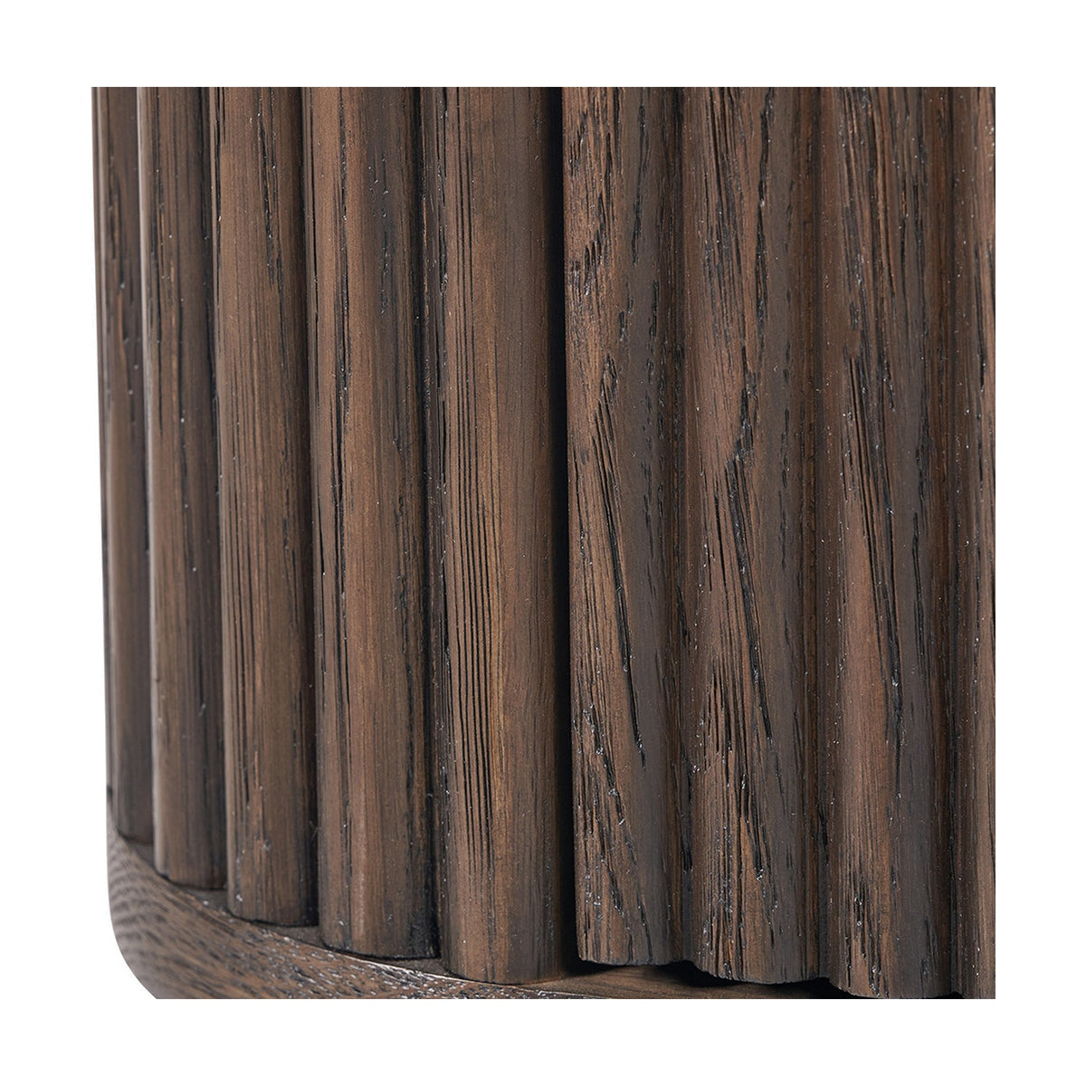 Close-up of the Raie 1 Drawer Unit's corner, showing dark brown ribbed oak and pine with a fluted, rounded vertical panel design.