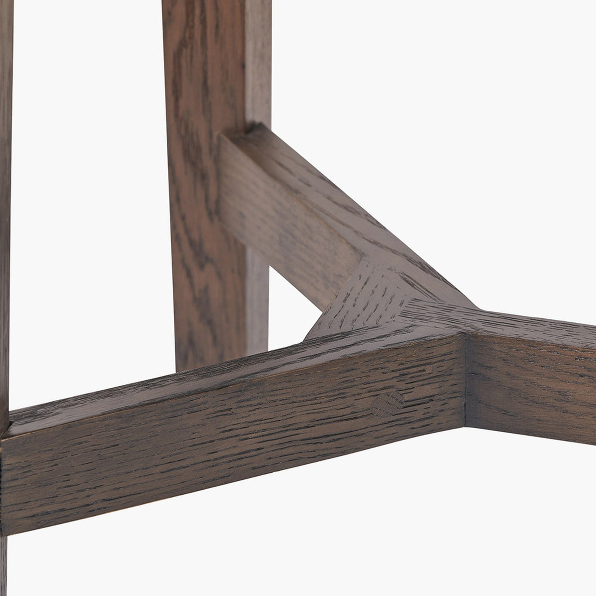 Close-up of the Raie Dark Brown Ribbed Oak & Pine 1 Drawer Unit's angled wooden leg joinery, showing dark brown ribbed oak grain and diagonal pine bracing on a white background.